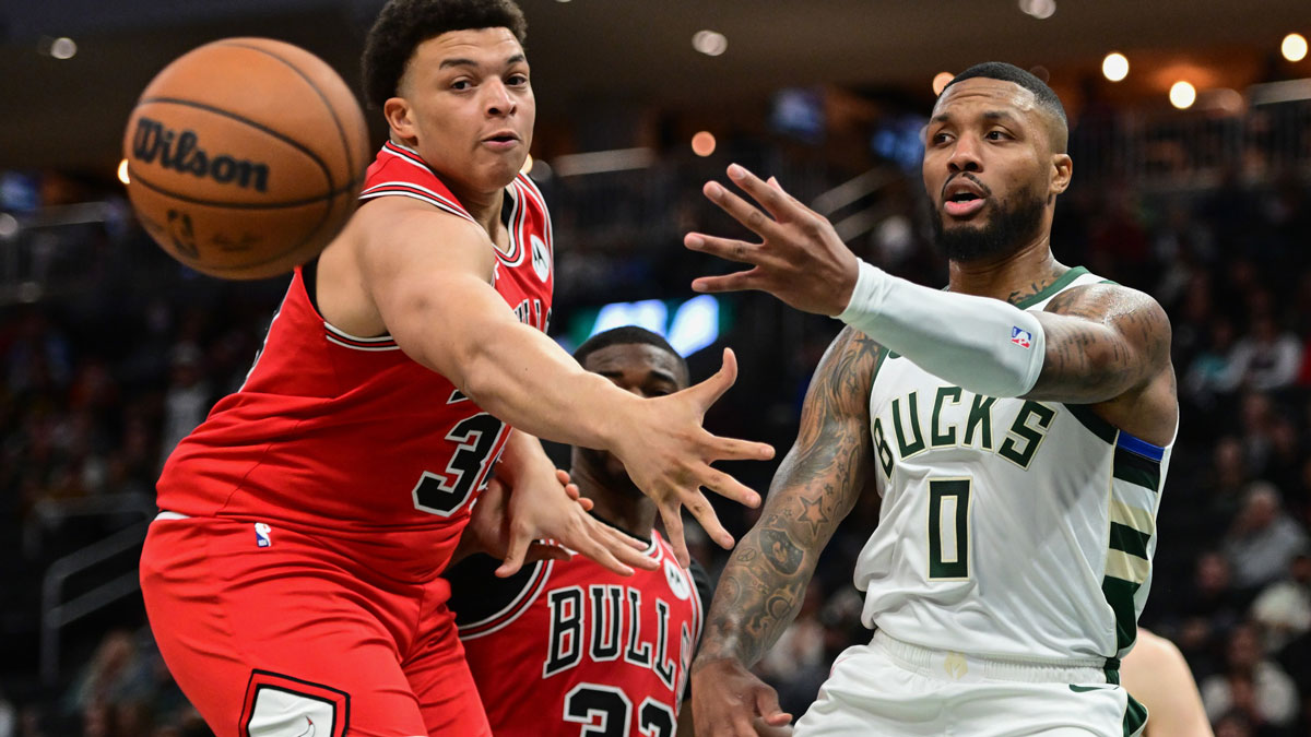 Milwaukee Bucks guard Damian Lillard (0) passes the ball in front of Chicago Bulls forward Kenneth Lofton Jr. (34) in the third quarter at Fiserv Forum.