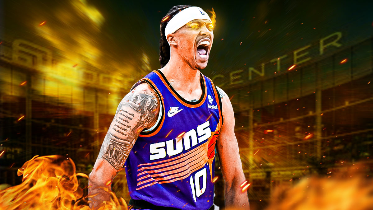 Phoenix Suns guard Damion Lee hyped with fire in his eyes, with a background of the inside of Footprint Center.