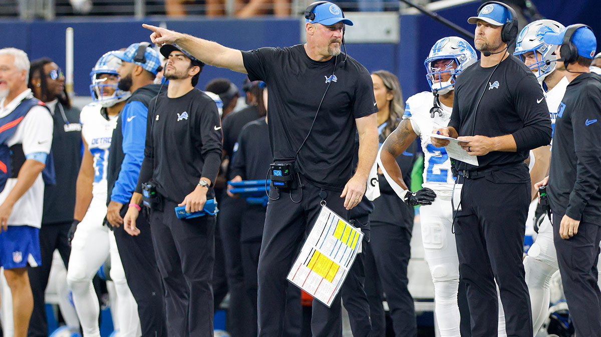 Detroit Lions Head Coach Dan Campbell talks with his coaches on the sideline during the second quarter against the Dallas Cowboys at AT&T Stadium.