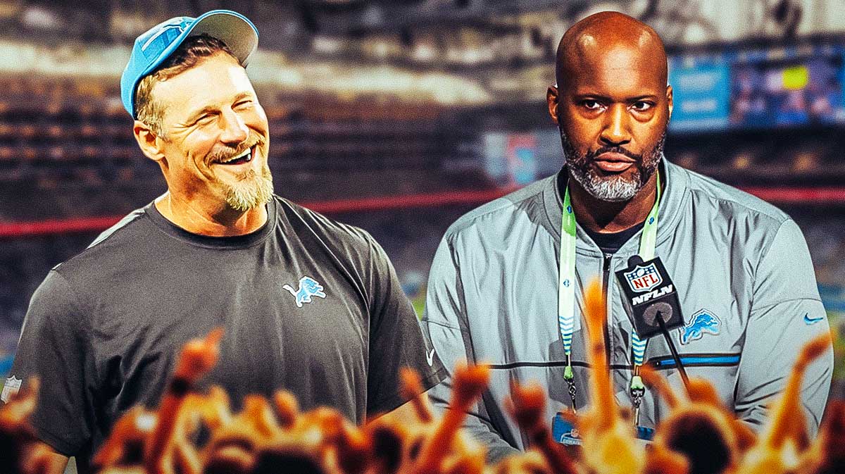 Detroit Lions head coach Dan Campbell smiling, alongside Lions general manager Brad Holmes with a background of Ford Field.