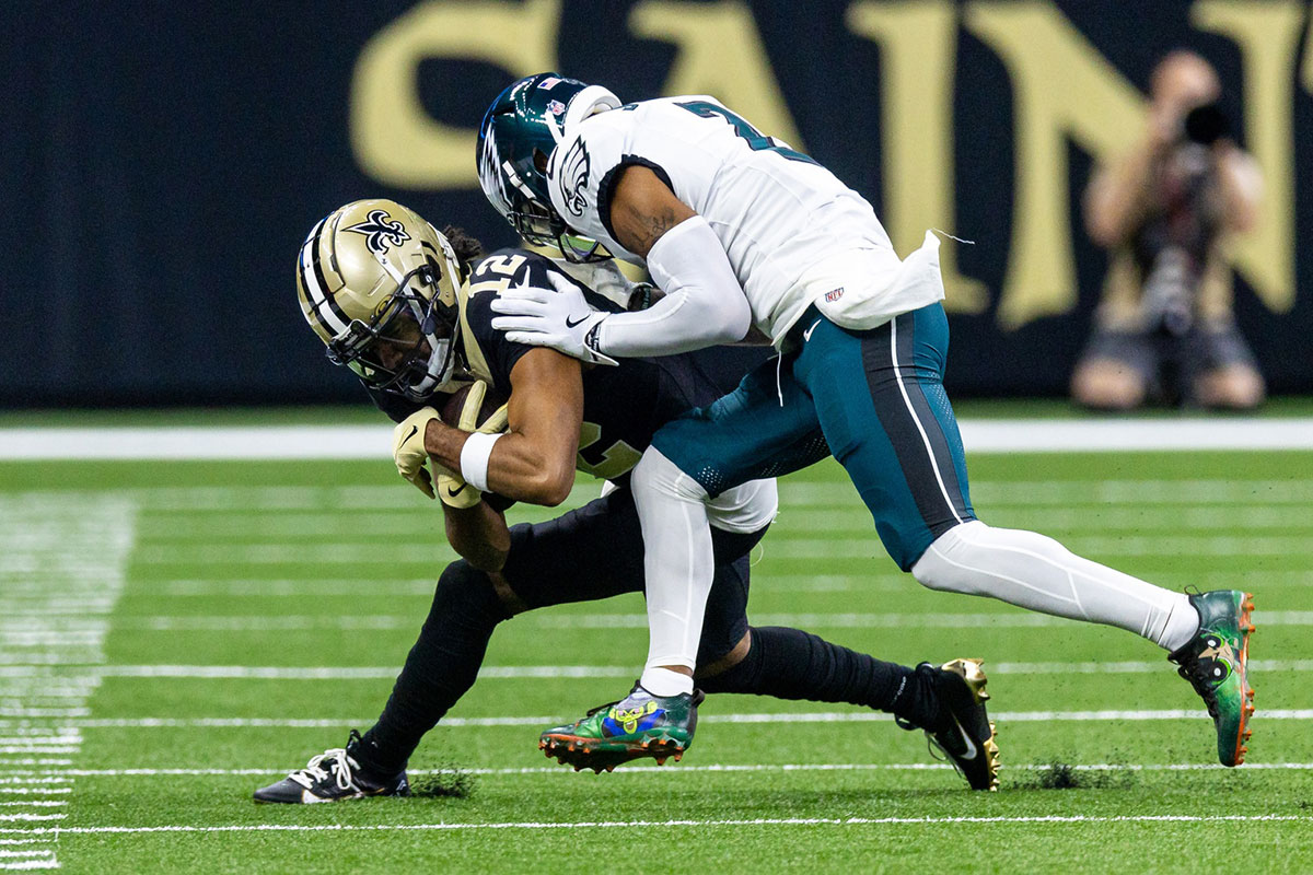 New Orleans Saints wide receiver Chris Olave (12) is pushed out of bounds by Philadelphia Eagles cornerback Darius Slay Jr. (2) during the first half at Caesars Superdome.