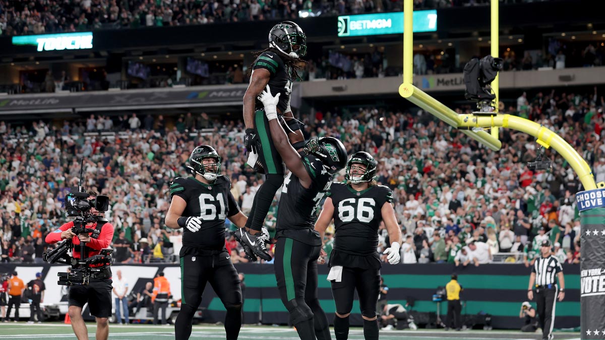 New York Jets wide receiver Davante Adams (17) celebrates his touchdown against the Houston Texans with offensive tackles Olu Fashanu (74) and Max Mitchell (61) and center Joe Tippmann (66) during the fourth quarter at MetLife Stadium.