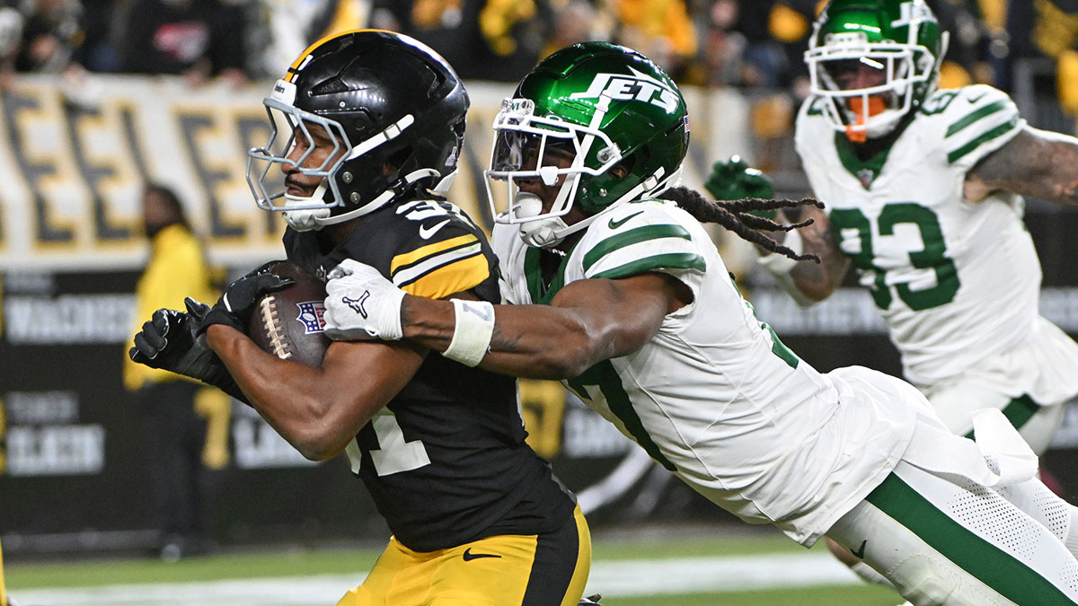 Pittsburgh Steelers cornerback Beanie Bishop Jr. (31) returns an interception while being pursued by New York Jets wide receiver Davante Adams (17) during the third quarter at Acrisure Stadium.