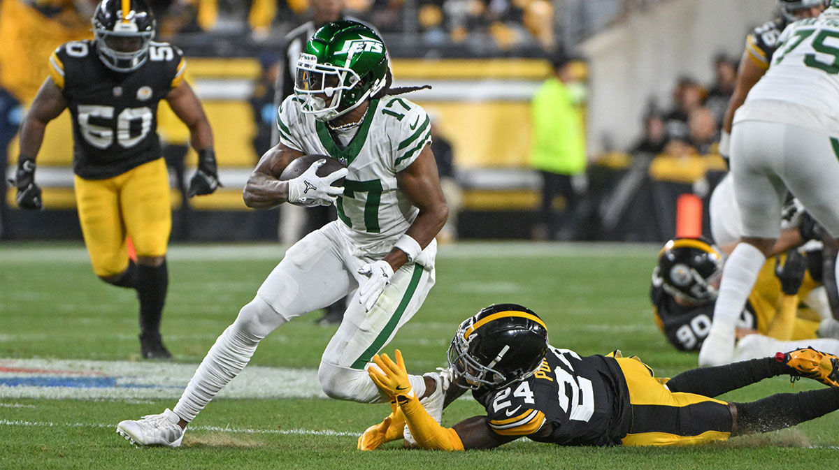 New York Jets wide receiver Davante Adams (17) eludes Pittsburgh Steelers cornerback Joey Porter Jr. (24) on a pass during the first quarter at Acrisure Stadium.