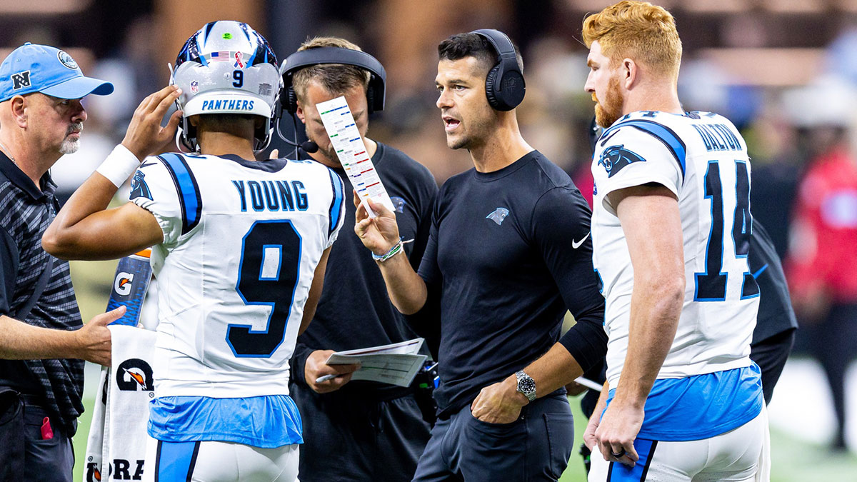 Carolina Panthers head coach Dave Canales talks to quarterback Bryce Young (9) and quarterback Andy Dalton (14) on a time out against the New Orleans Saints during the first half at Caesars Superdome.