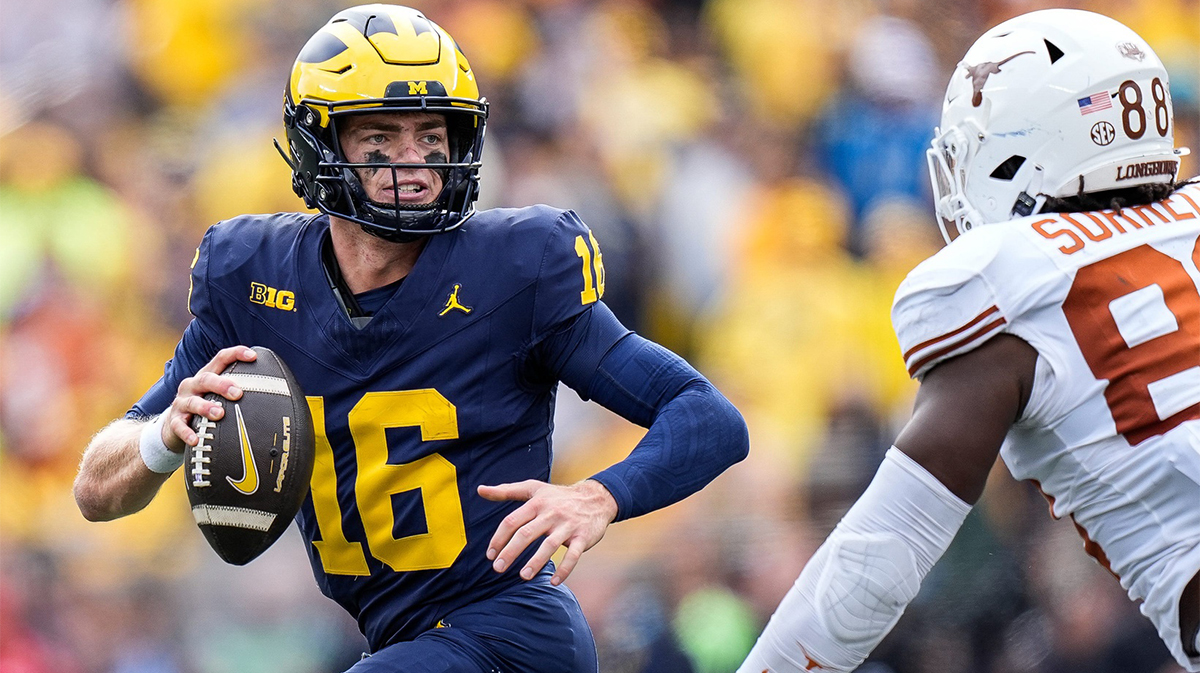 Michigan quarterback Davis Warren (16) looks to makes a pass against Texas linebacker Barryn Sorrell (88) during the second half at Michigan Stadium in Ann Arbor on Saturday, September 7, 2024.