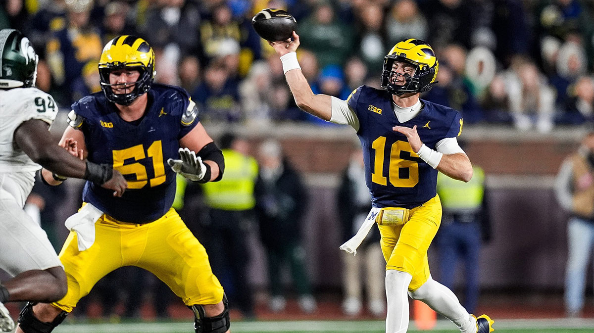 Michigan quarterback Davis Warren (16) makes a pass against Michigan State during the second half at Michigan Stadium