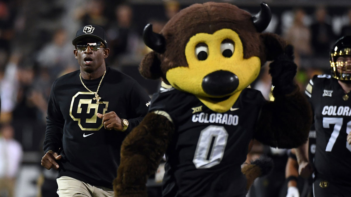 Colorado Buffaloes head coach Deion Sanders runs onto the field with his team before the game against the Kansas State Wildcats at Folsom Field.