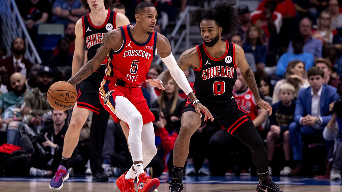 New Orleans Pelicans guard Dejounte Murray (5) dribbles against Chicago Bulls guard Coby White (0) during the first half at Smoothie King Center.