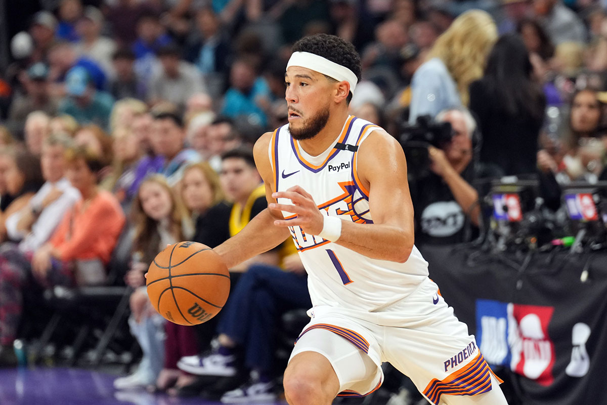 Phoenix Suns guard Devin Booker (1) dribbles against the Los Angeles Lakers during the first half at Footprint Center.