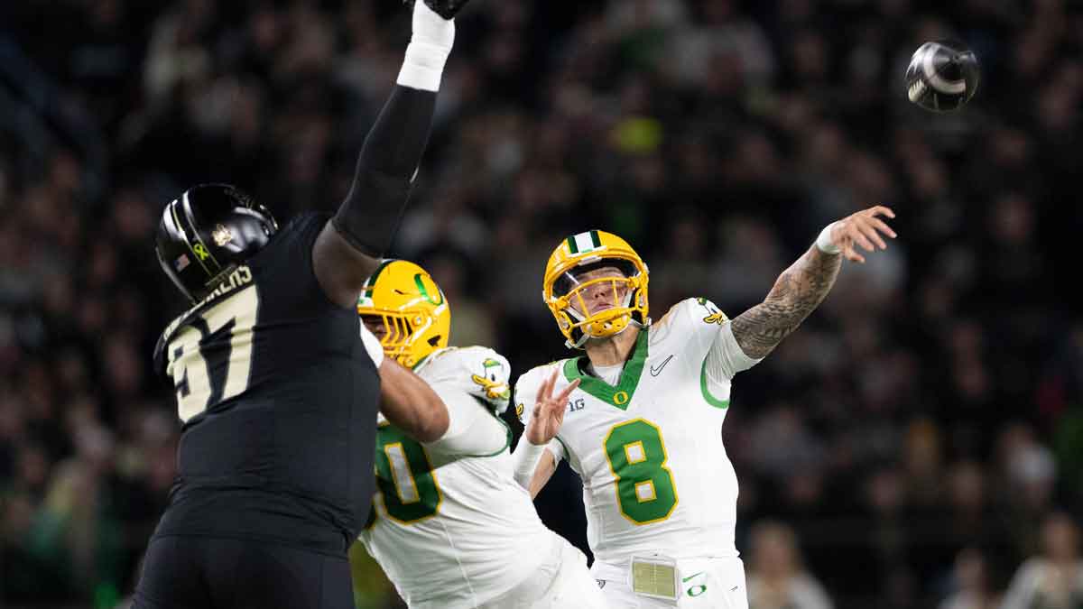 Oregon Ducks quarterback Dillon Gabriel (8) throws a pass in front of Purdue Boilermakers defensive lineman Jamarrion Harkless (97) at Ross-Ade Stadium.