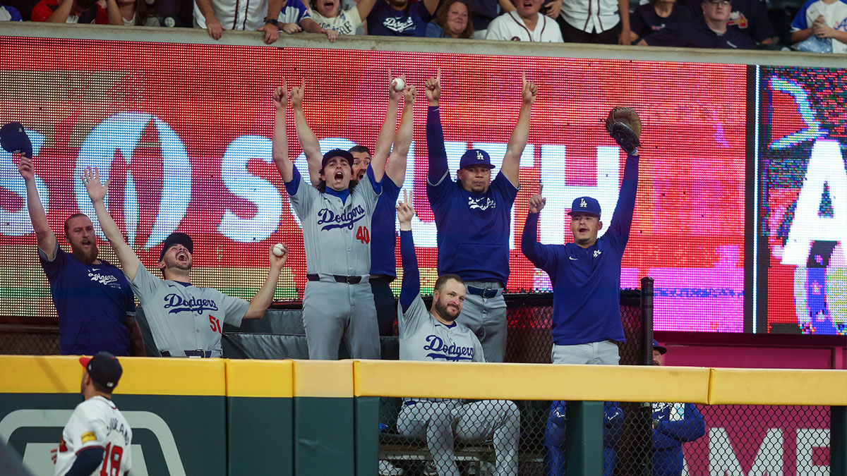 The Los Angeles Dodgers bullpen reacts after a home run hit by first baseman Freddie Freeman (not pictured) against the Atlanta Braves as left fielder Ramon Laureano (18) looks on in the seventh inning at Truist Park. 