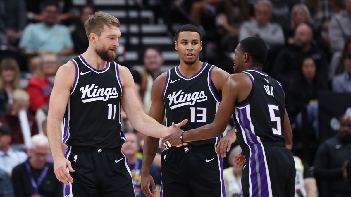 Sacramento Kings forward Domantas Sabonis (11), forward Keegan Murray (13) and guard De'Aaron Fox (5) react during the second quarter of the game against the Utah Jazz at Delta Center