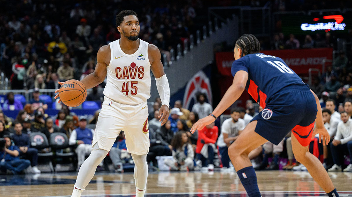 Cleveland Cavaliers guard Donovan Mitchell (45) dribbles the ball against Washington Wizards forward Kyshawn George (18) during the fourth quarter at Capital One Arena.