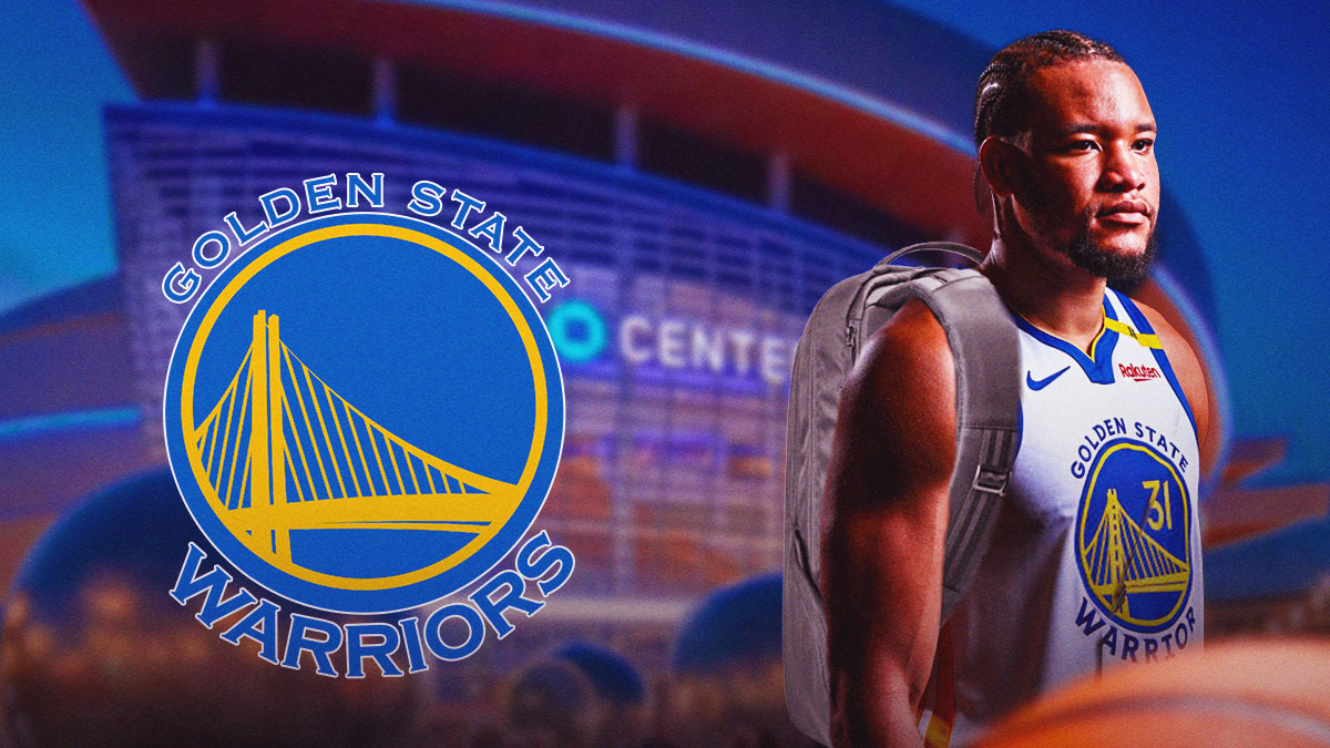 Kevin Knox with a backpack on, and his back turned facing the Chase Center. There's also a Golden State Warriors logo to his side.