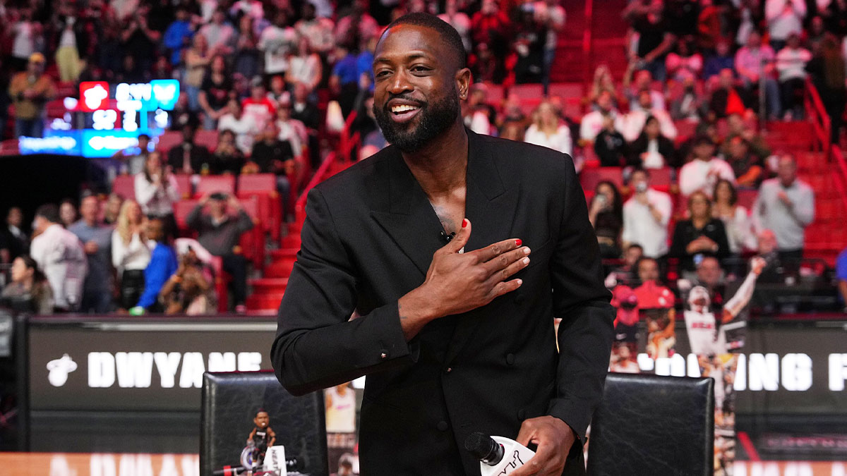 Former Miami Heat player Dwayne Wade acknowledges the fans and cameras after a special ceremony during halftime of the game between the Miami Heat and the Charlotte Hornets at Kaseya Center.