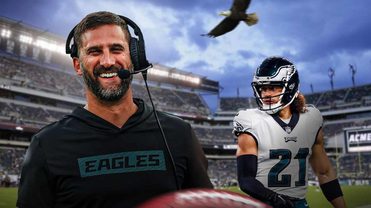 Nick Sirianni next to Sydney Brown in their Eagles gear in front of an Eagles motif.