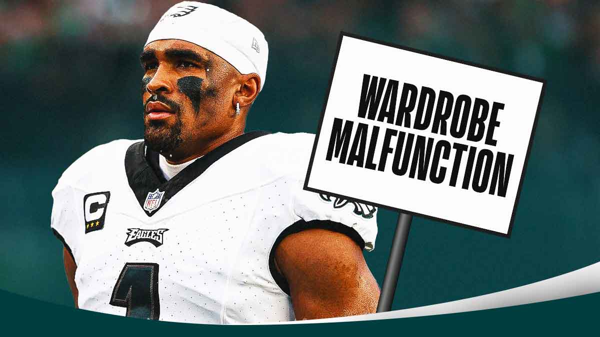 Eagles' Jalen Hurts next to a sign that says WARDROBE MALFUNCTION