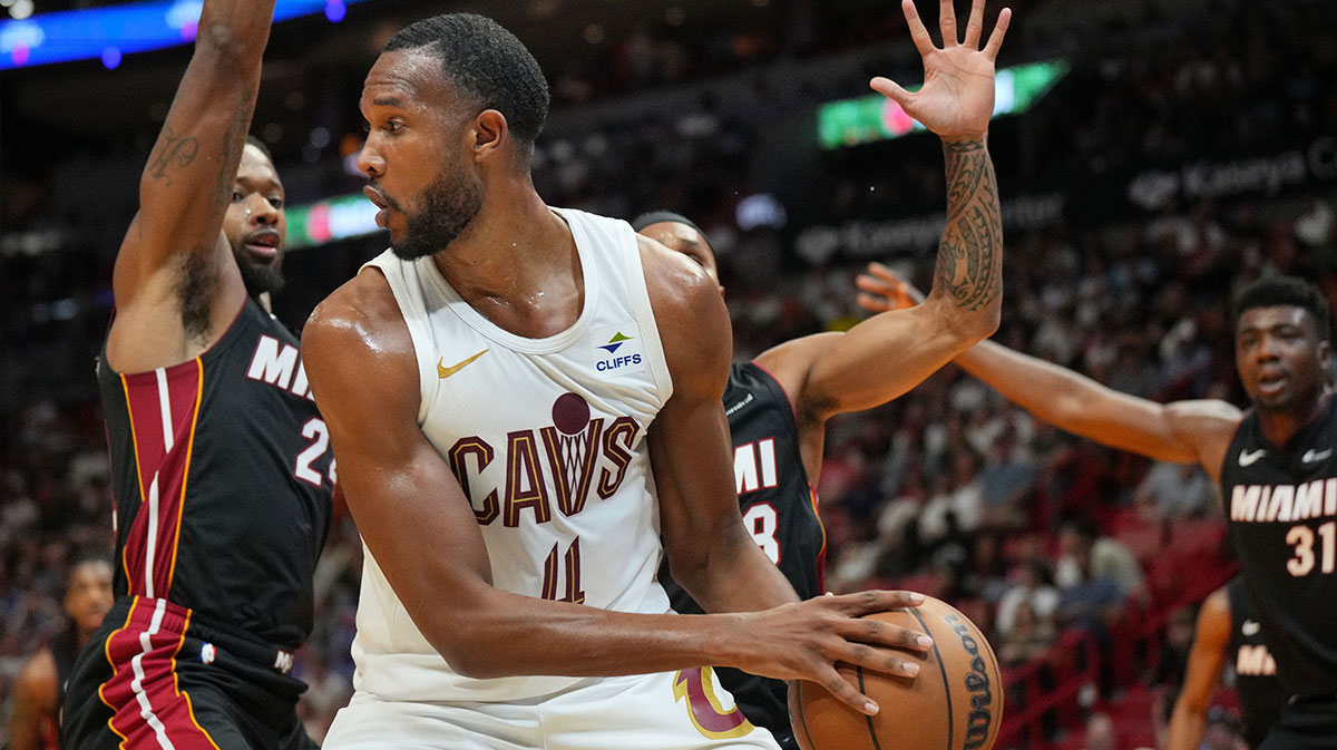 Cleveland Cavaliers forward Evan Mobley (4) looks to pass the ball as Miami Heat forward Haywood Highsmith (24) and guard Patty Mills (88) defend during the second half at the Kaseya Center.