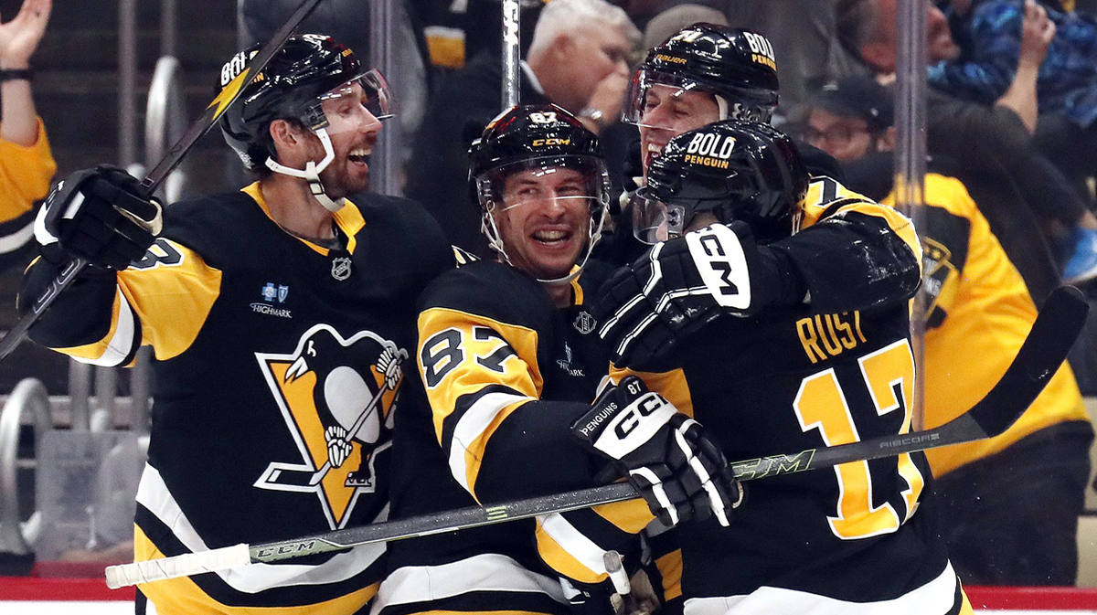 Pittsburgh Penguins defenseman Marcus Pettersson (left), center Sidney Crosby (87), and right wing Bryan Rust (17) congratulate center Evgeni Malkin (71) on his 500th career NHL goal against the Buffalo Sabres during the third period at PPG Paints Arena.