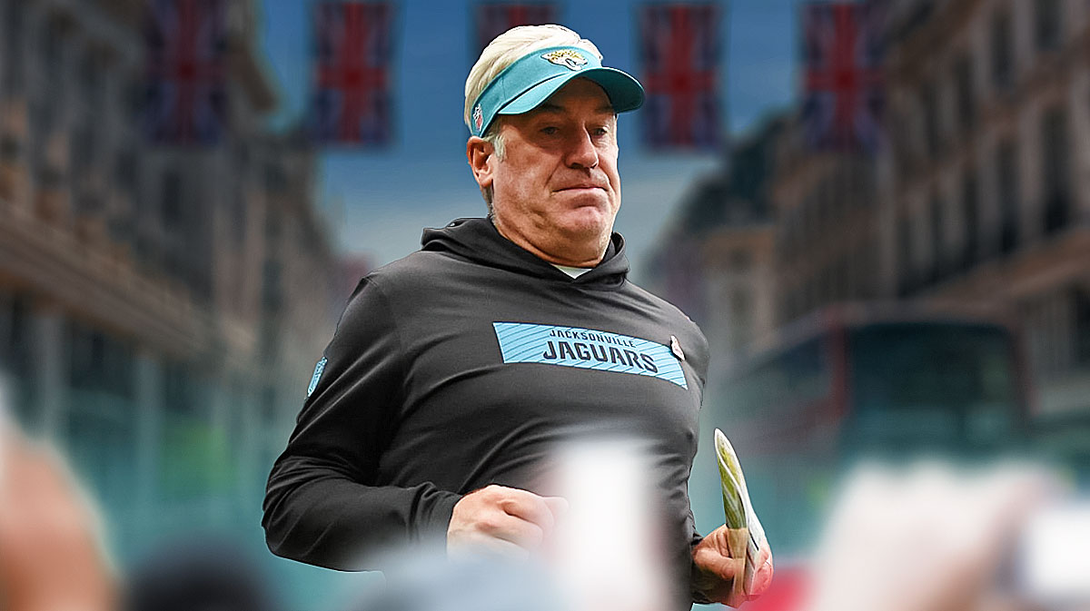 Doug Pederson with his head down and a London background.