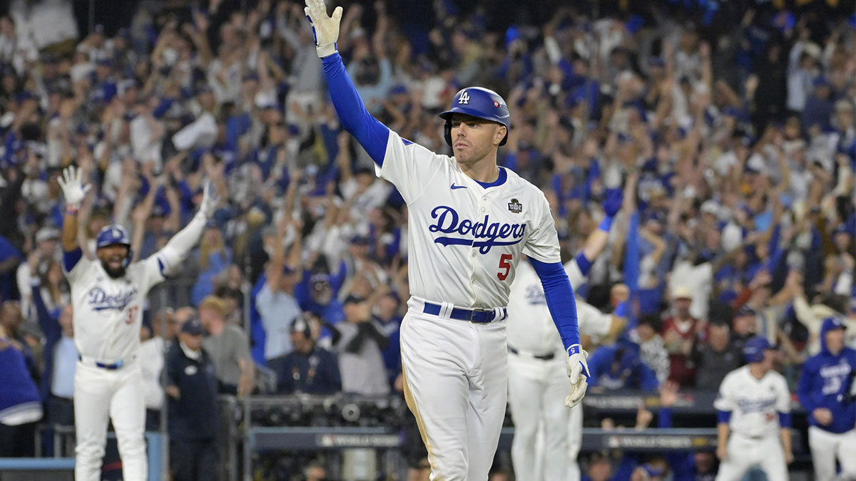 Los Angeles Dodgers first baseman Freddie Freeman (5) celebrates after hitting a grand slam home run in the tenth inning against the New York Yankees during game one of the 2024 MLB World Series at Dodger Stadium.