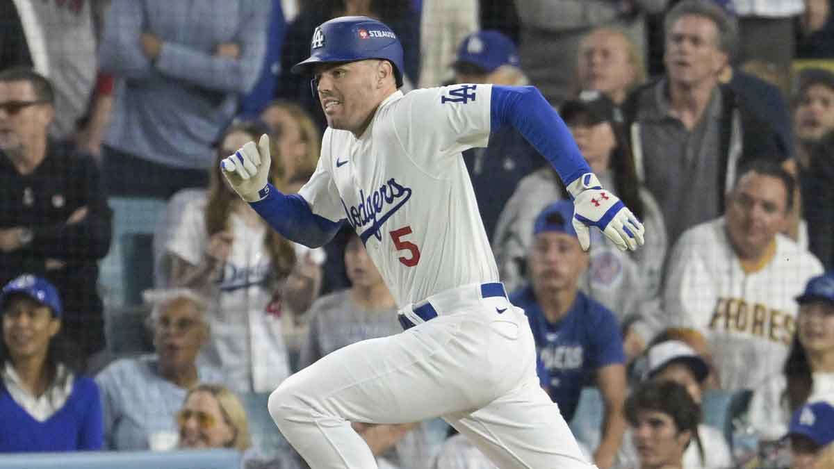 Los Angeles Dodgers first baseman Freddie Freeman (5) runs to first on a single in the fourth inning against the San Diego Padres during game one of the NLDS for the 2024 MLB Playoffs at Dodger Stadium.