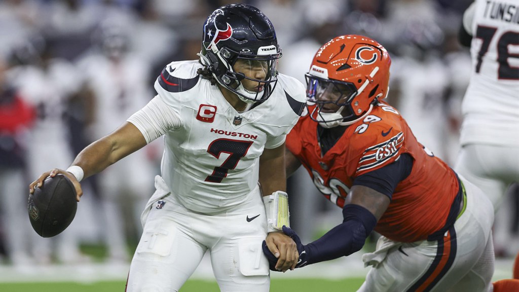 Houston Texans quarterback C.J. Stroud (7) attempts to escape a tackle by Chicago Bears defensive tackle Gervon Dexter Sr. (99) during the fourth quarter at NRG Stadium. 