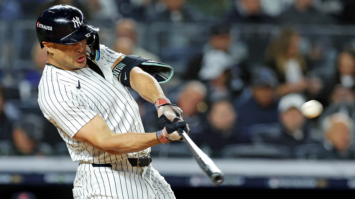 New York Yankees designated hitter Giancarlo Stanton (27) hits a solo home run during the seventh inning against the Cleveland Guardians in game one of the ALCS for the 2024 MLB Playoffs at Yankee Stadium.