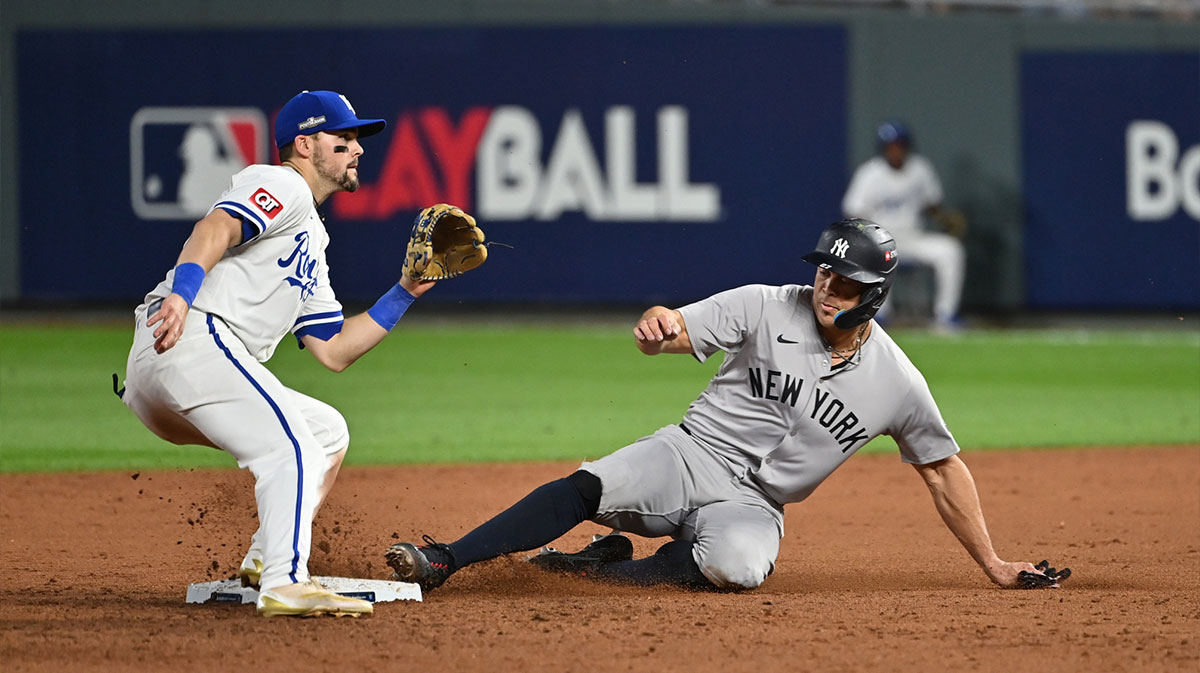 New York Yankees designated hitter Giancarlo Stanton (27) steals second base in the sixth inning against the Kansas City Royals during game three of the NLDS for the 2024 MLB Playoffs at Kauffman Stadium.