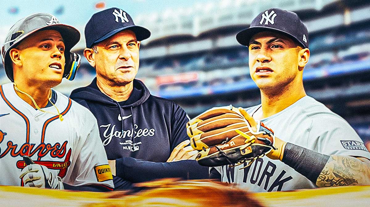 Gleyber Torres (Yankees) looking serious, Aaron Boone and Gio Urshela in background