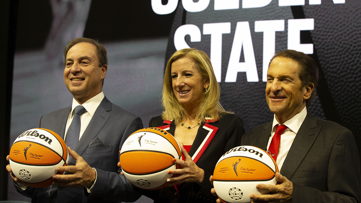 Golden State Warriors co-executive director & chief executive officer Joe Lacob, WNBA commissioner Cathy Engelbert and Warriors co-executive director Peter Guber pose for a group photo during a press conference to announce an expansion WNBA franchise in the San Francisco Bay Area at Chase Center.