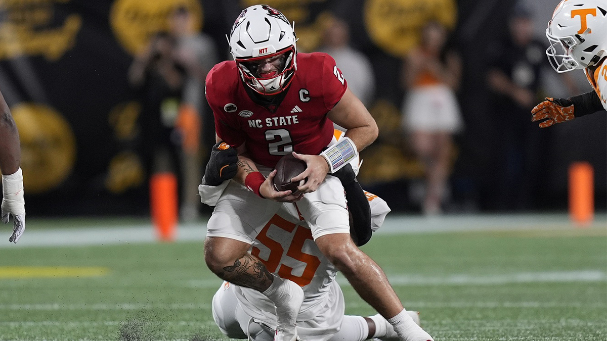 North Carolina State Wolfpack quarterback Grayson McCall (2) is tackled by Tennessee Volunteers defensive lineman Omarr Norman-Lott (55) during the first quarter at the Dukes Mayo Classic at Bank of America Stadium.