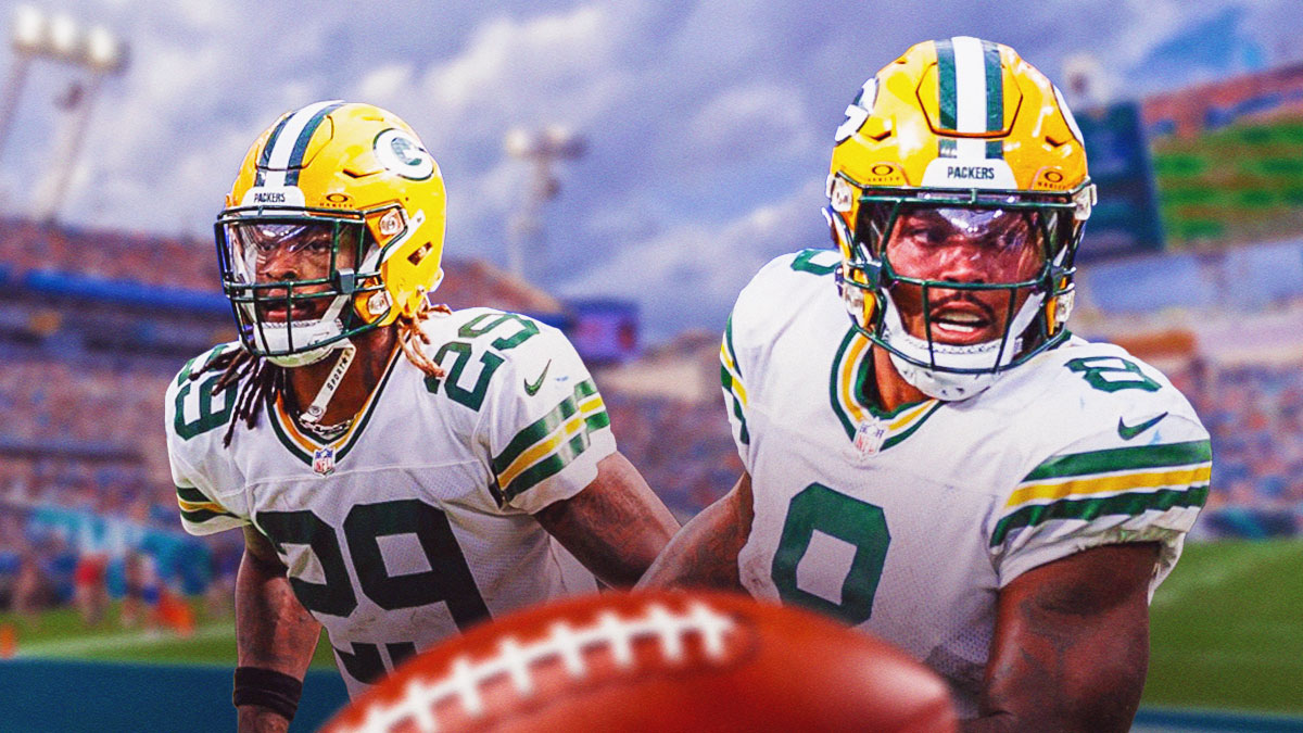 Xavier McKinney of the Green Bay Packers and Josh Jacobs of the Packers with a background of EverBank Stadium, where the Jaguars play.