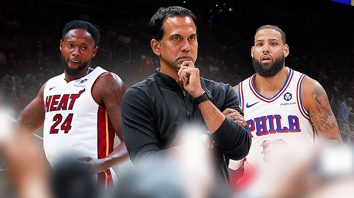 Miami Heat head coach Erik Spoelstra in the middle of Haywood Highsmith and Caleb Martin in front of Kaseya Center.