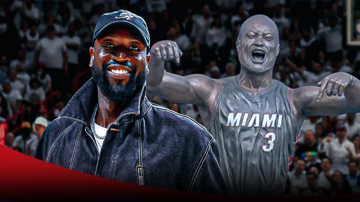 Dwayne Wade laughs next to the new statue of him