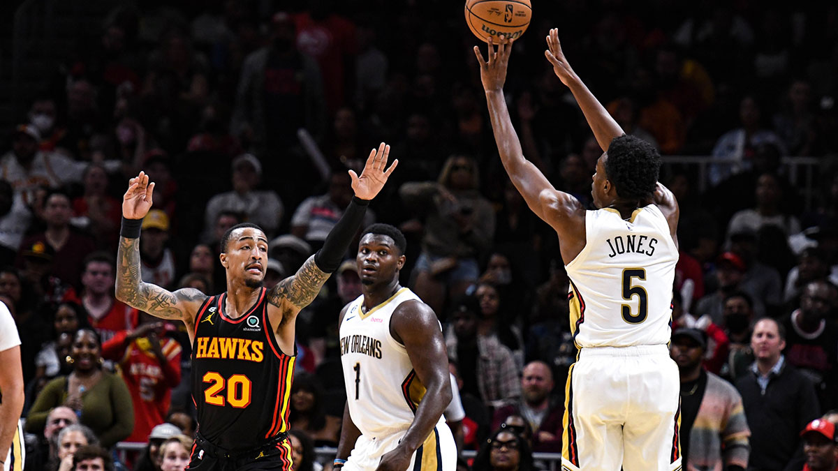 New Orleans Pelicans forward Herb Jones (5) shoots a three-point shot over Atlanta Hawks forward John Collins (20) in the fourth quarter at State Farm Arena.