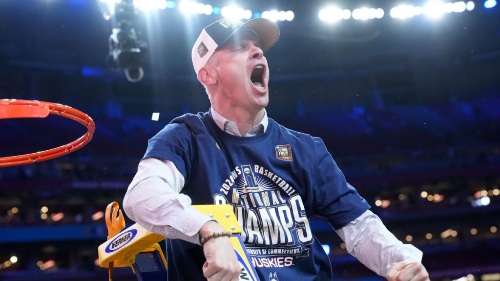 Connecticut Huskies head coach Dan Hurley cuts down the cut after defeating the Purdue Boilermakers in the national championship game of the 2024 NCAA Tournament at State Farm Stadium in Glendale on April 8, 2024.