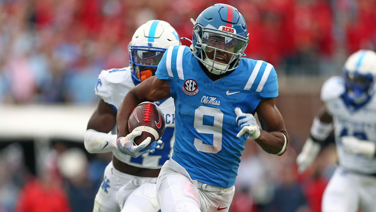 Mississippi Rebels wide receiver Tre Harris (9) runs after a catch for a first down as Kentucky Wildcats defensive back Jordan Lovett (25) pursues during the second half at Vaught-Hemingway Stadium.