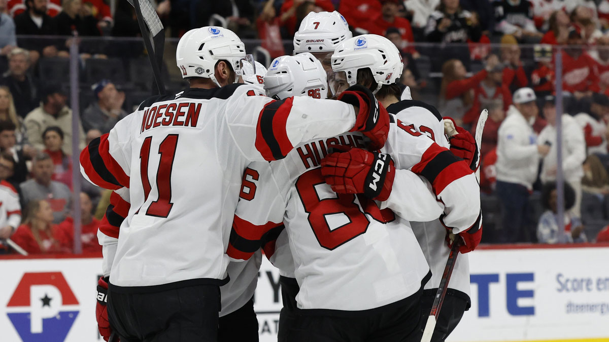 New Jersey Devils center Nico Hischier (13) receives congratulations from teammates after scoring in the third period against the Detroit Red Wings at Little Caesars Arena.