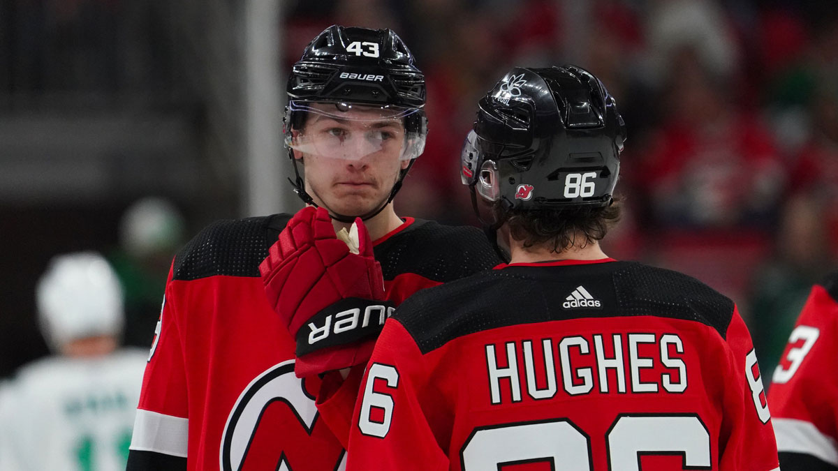 New Jersey Devils center Jack Hughes (86) and defenseman Luke Hughes (43) talk against the Carolina Hurricanes during the first period at PNC Arena.