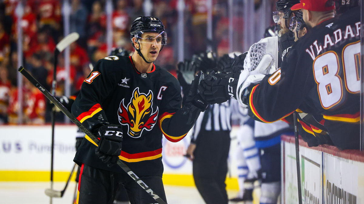 Calgary Flames center Mikael Backlund (11) celebrates his goal with teammates against the Winnipeg Jets during the first period at Scotiabank Saddledome.