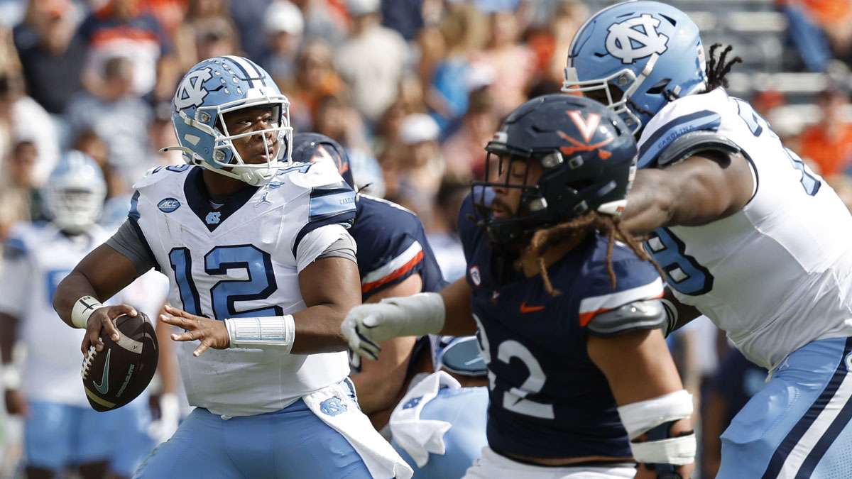 North Carolina Tar Heels quarterback Jacolby Criswell (12) passes the ball as Virginia Cavaliers defensive back Elijah Gaines (22) defends during the first half at Scott Stadium.