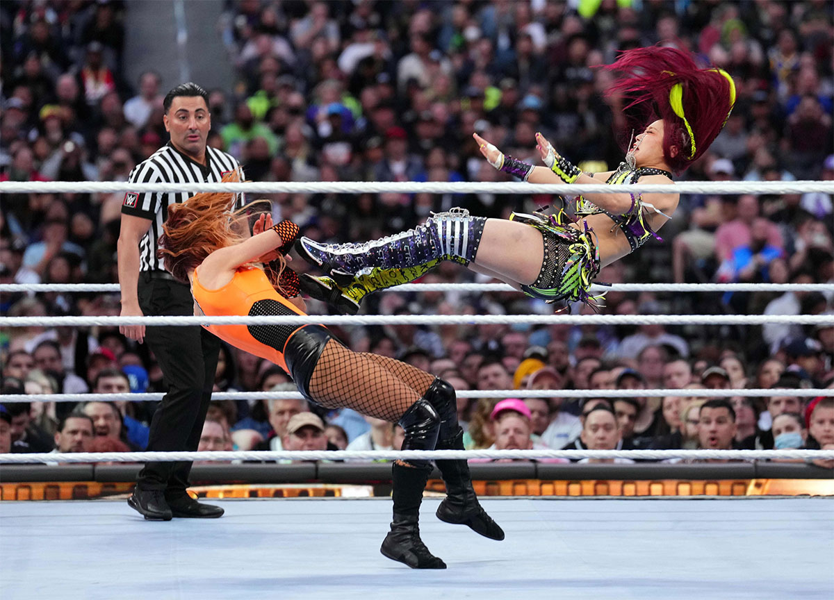 Iyo Sky kicking Becky Lynch at WrestleMania 39.