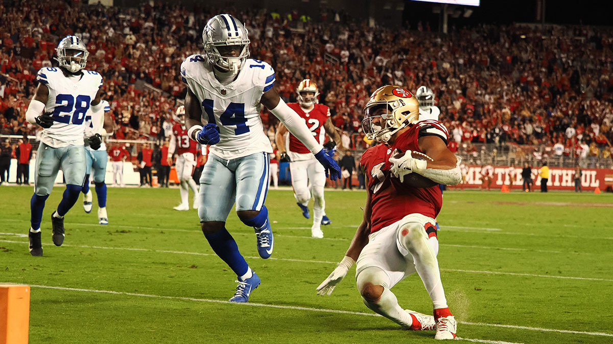 San Francisco 49ers running back Isaac Guerendo (31) slides short of the goal line in the final seconds of the game against Dallas Cowboys safety Markquese Bell (14) during the fourth quarter at Levi's Stadium.