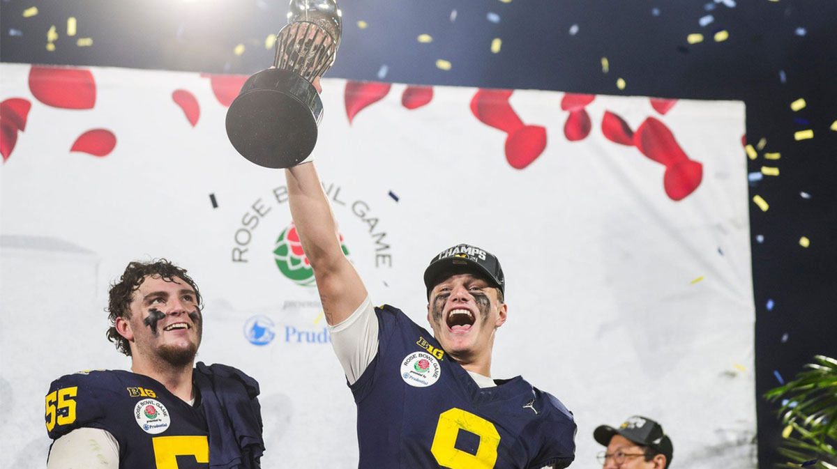 Michigan quarterback J.J. McCarthy lifts the Rose Bowl trophy to celebrate after the team's defeat of Alabama in the College Football Playoff semifinal at Rose Bowl Stadium