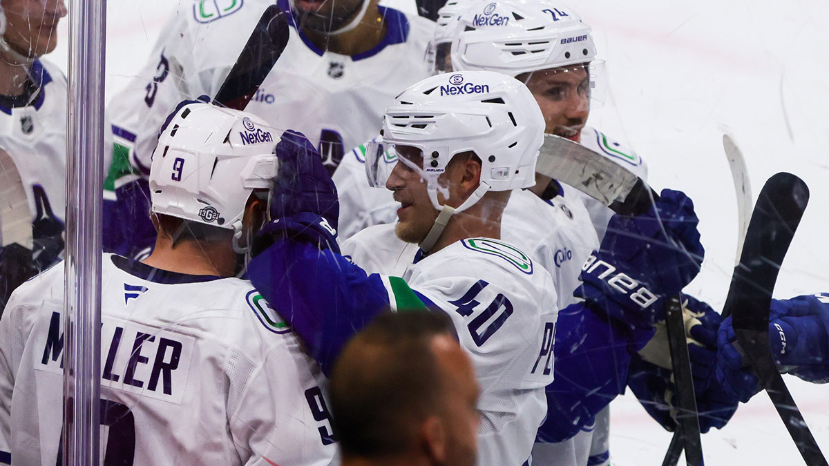 Vancouver Canucks center J.T. Miller (9) celebrates with teammates after scoring the game-winning goal against the Florida Panthers during overtime at Amerant Bank Arena.