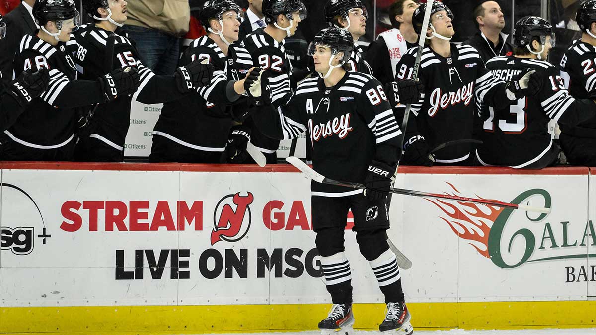 New Jersey Devils center Jack Hughes (86) celebrates with teammates after scoring a goal against the Nashville Predators during the first period at Prudential Center.