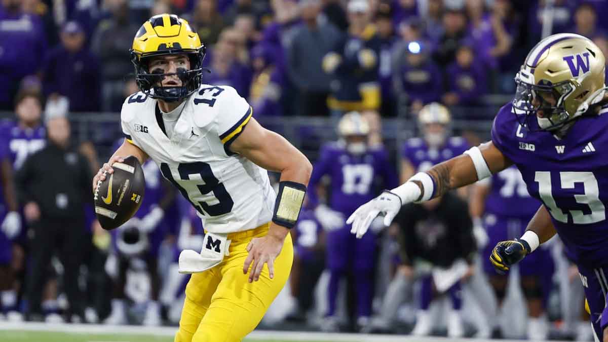 Michigan Wolverines quarterback Jack Tuttle (13) looks to pass against the Washington Huskies during the third quarter at Alaska Airlines Field at Husky Stadium.