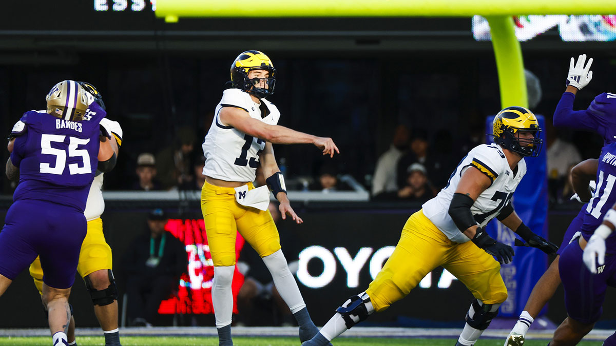 Michigan Wolverines quarterback Jack Tuttle (13) passes against the Washington Huskies during the second quarter at Alaska Airlines Field at Husky Stadium.